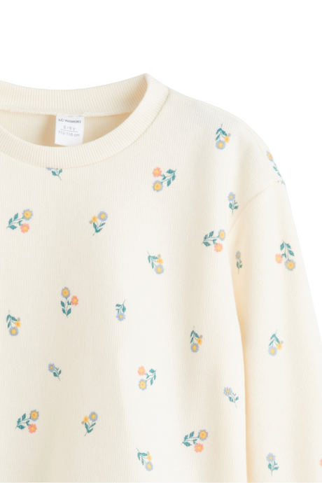Sporline LC Waikiki çocuk sweatshirt, krem rengi zemin üzerinde pastel tonlarda çiçek desenli, bisiklet yaka tasarım.