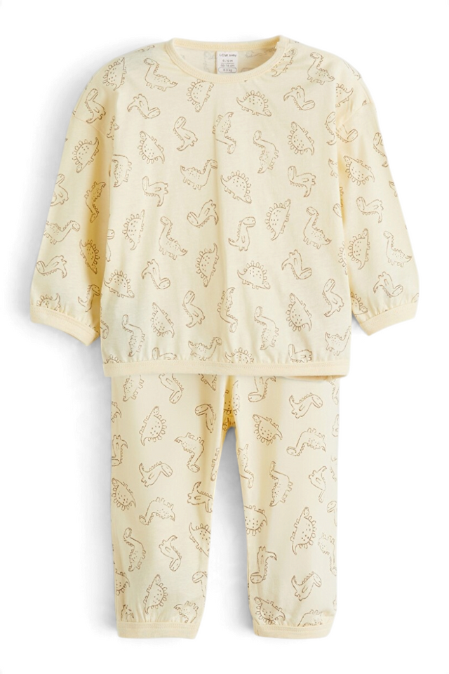 Sporline LC Waikiki çocuk pijama takımı, kırık beyaz renkli, dinozor desenli, %100 pamuklu rahat ev giyimi.